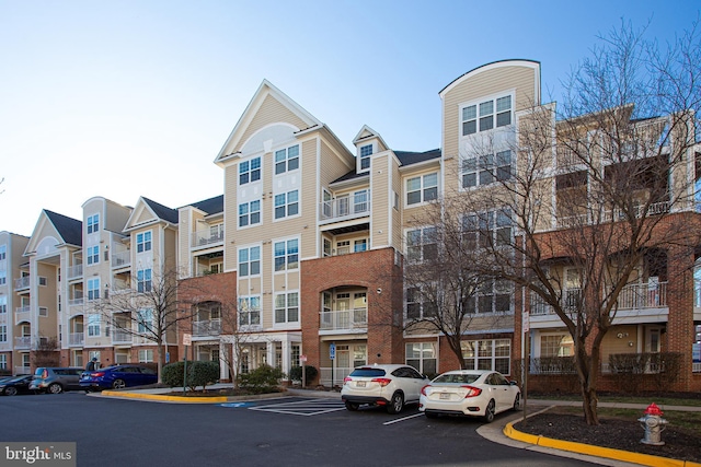 view of building exterior featuring uncovered parking