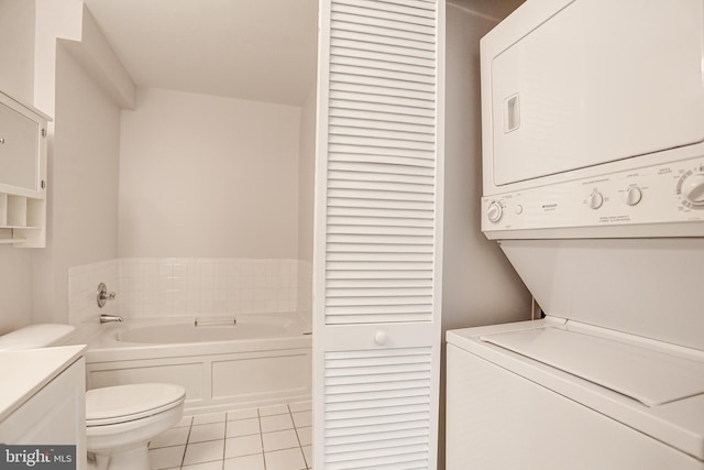 laundry room featuring light tile patterned floors and stacked washer and clothes dryer