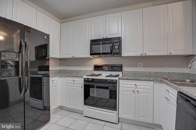 kitchen featuring white cabinets, sink, light tile patterned flooring, and black appliances