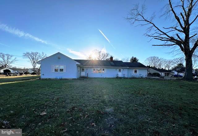 rear view of house with a yard