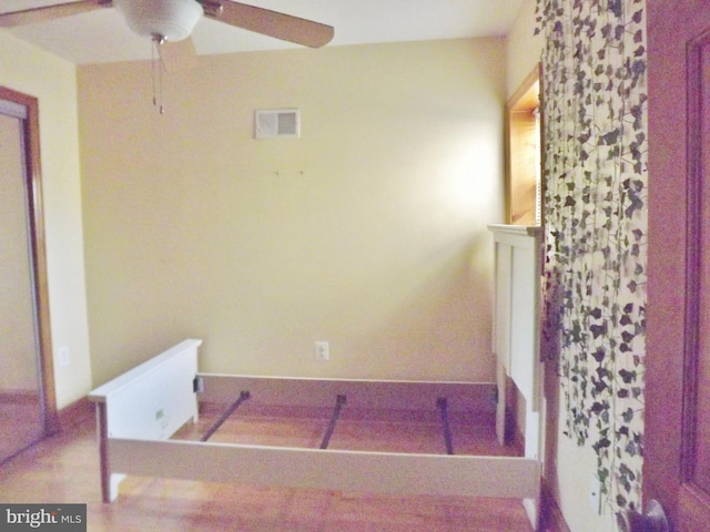 interior space with ceiling fan