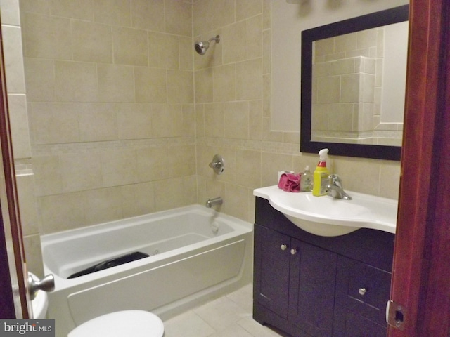 full bathroom featuring vanity, tiled shower / bath combo, tile patterned floors, and toilet