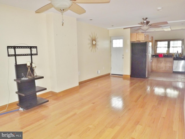 unfurnished living room with ceiling fan and light wood-type flooring