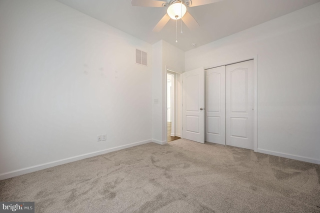 unfurnished bedroom featuring a closet, visible vents, baseboards, and carpet