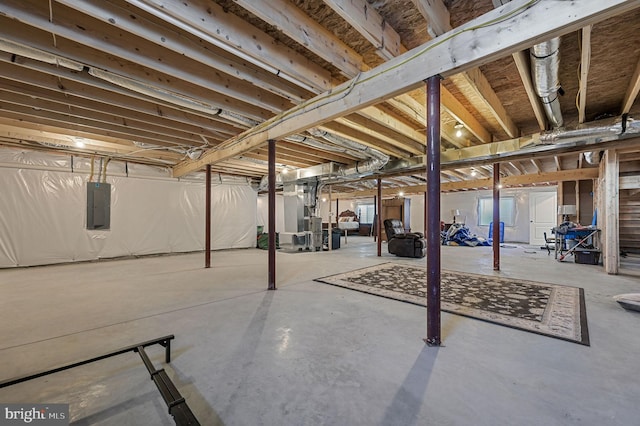 unfinished basement featuring electric panel