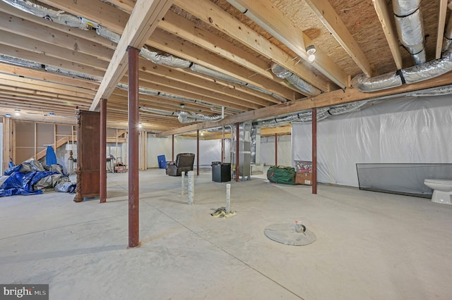 unfinished basement featuring heating unit