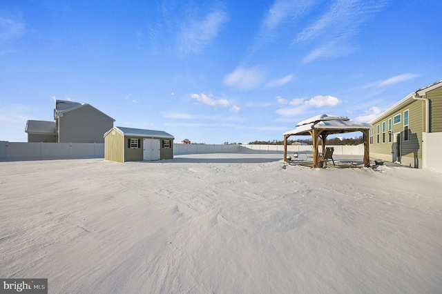 view of yard with a storage shed, a gazebo, an outbuilding, and a fenced backyard