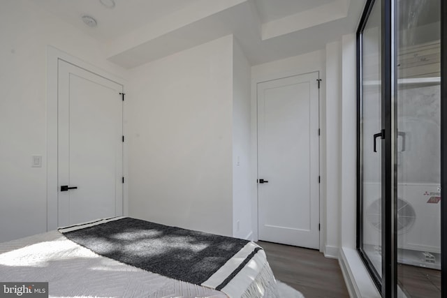 unfurnished bedroom featuring dark hardwood / wood-style flooring