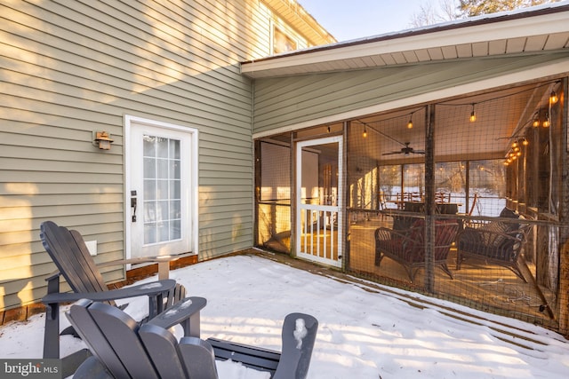 snow covered patio featuring ceiling fan