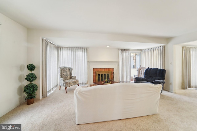 carpeted living room featuring a brick fireplace