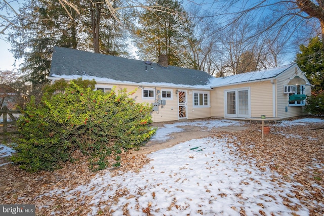 view of snow covered back of property