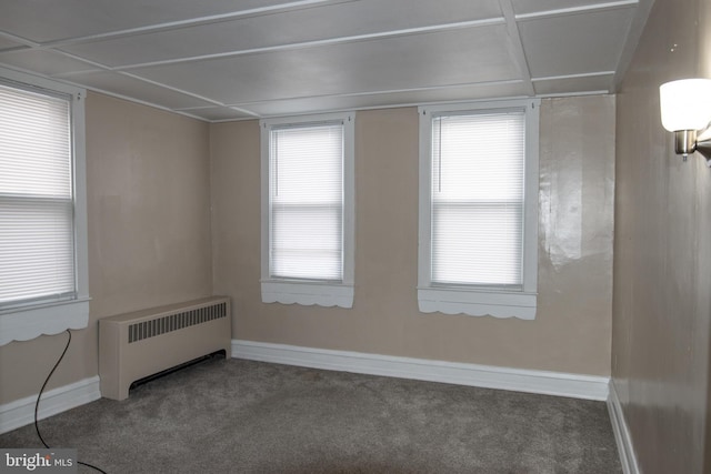 carpeted empty room featuring radiator