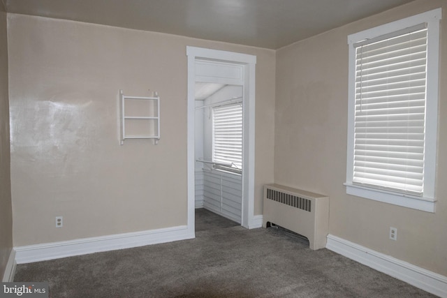 carpeted empty room with radiator