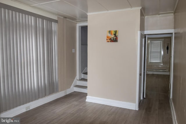 unfurnished room featuring dark hardwood / wood-style floors and crown molding