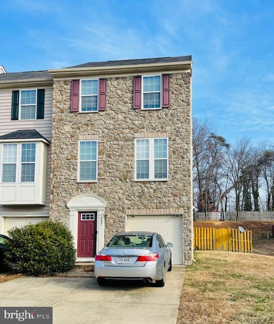 view of property featuring a front yard and a garage