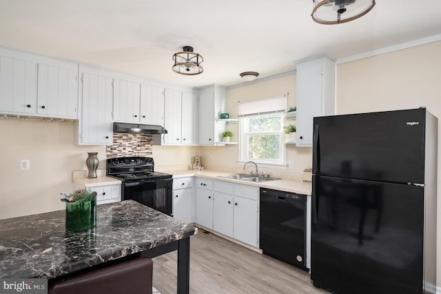 kitchen with premium range hood, sink, black appliances, light hardwood / wood-style flooring, and white cabinets