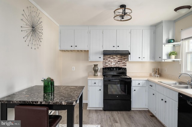 kitchen with white cabinets, sink, ventilation hood, and black appliances