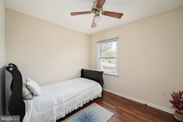 bedroom with ceiling fan and dark hardwood / wood-style floors