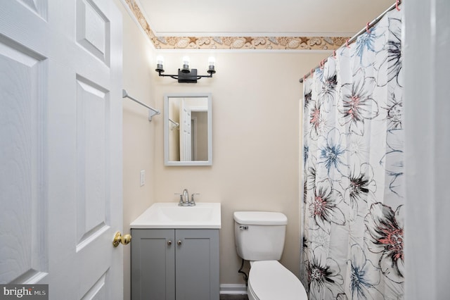 bathroom featuring vanity, toilet, and crown molding