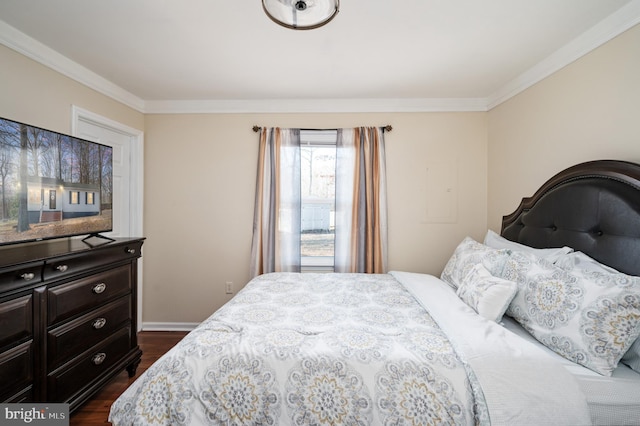 bedroom with crown molding and dark hardwood / wood-style floors