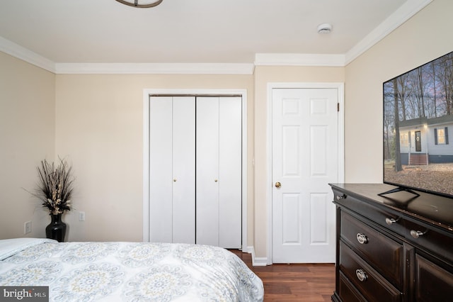 bedroom featuring dark hardwood / wood-style flooring, multiple closets, and crown molding