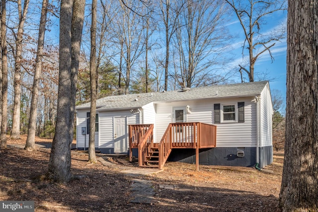 rear view of house with a wooden deck