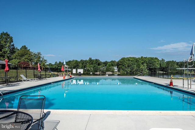 view of pool with a water view