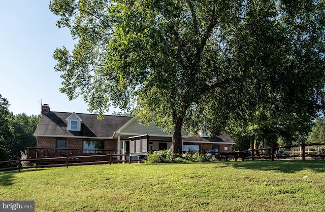 rear view of property with a yard