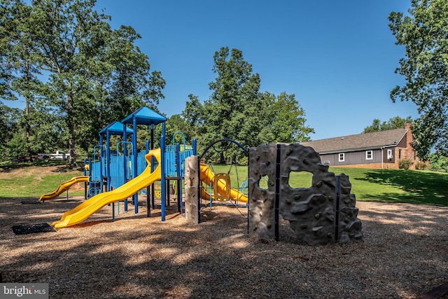 view of playground with a lawn