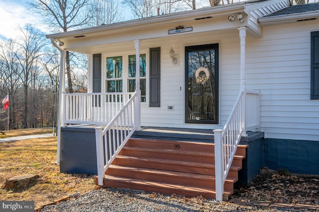 doorway to property featuring covered porch