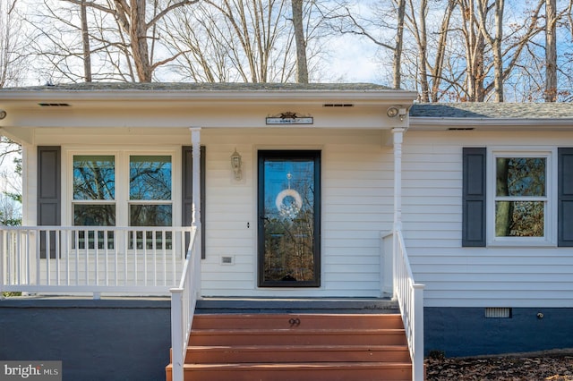 view of exterior entry featuring covered porch