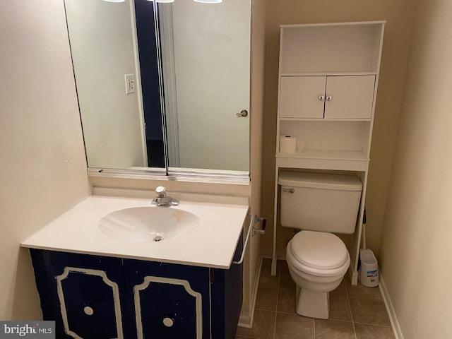 bathroom with tile patterned floors, vanity, and toilet