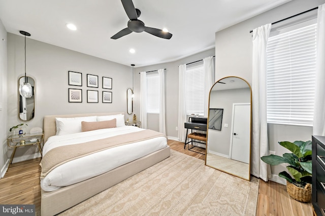 bedroom featuring light hardwood / wood-style floors and ceiling fan