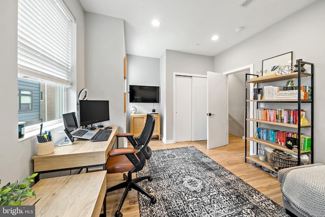 office area featuring light wood-type flooring and a healthy amount of sunlight