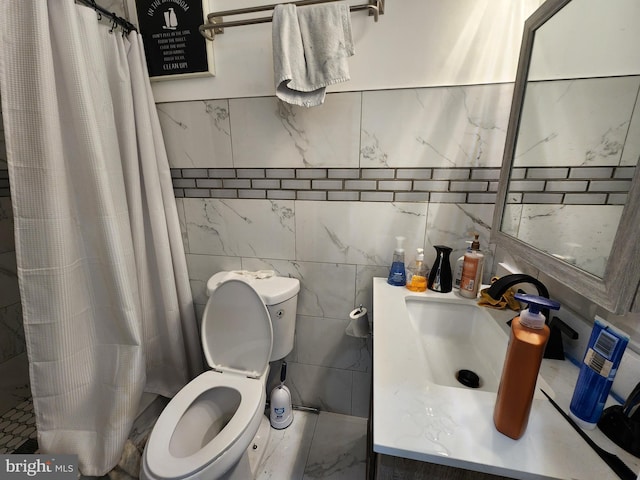 bathroom featuring a shower with shower curtain, vanity, toilet, and tile walls