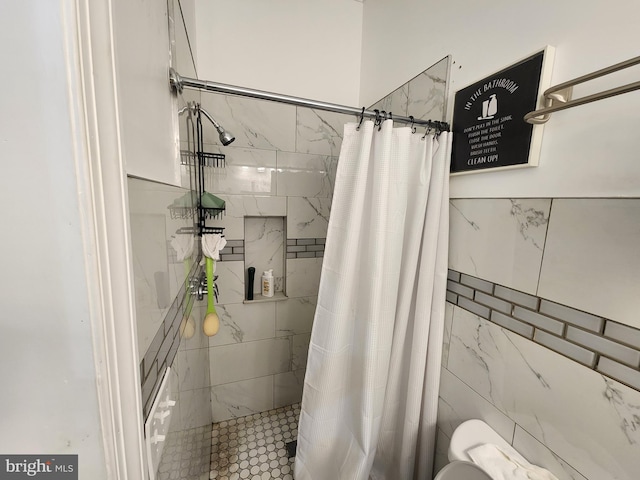 bathroom featuring a shower with curtain and tile walls