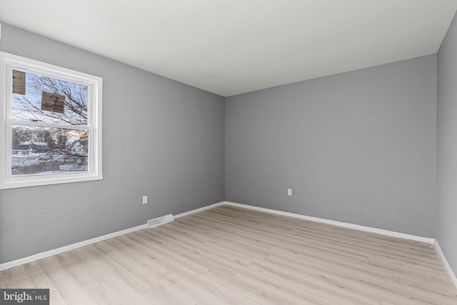 spare room featuring light wood-type flooring