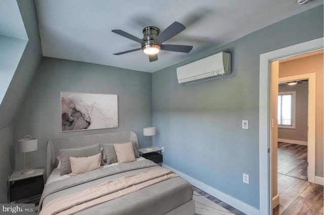 bedroom featuring hardwood / wood-style flooring, ceiling fan, and an AC wall unit