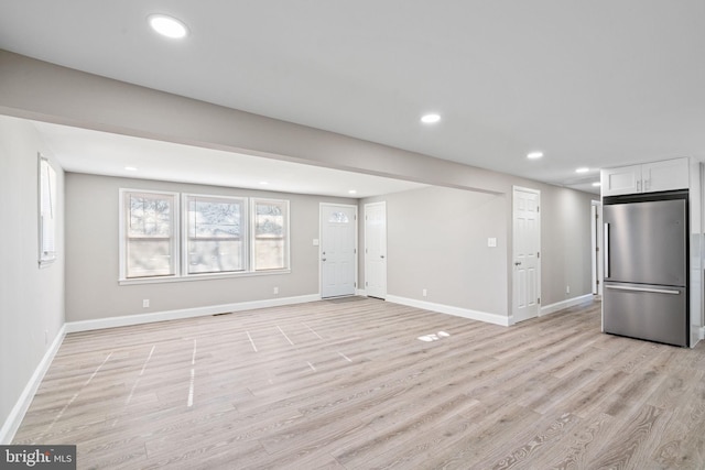 unfurnished living room featuring light hardwood / wood-style flooring