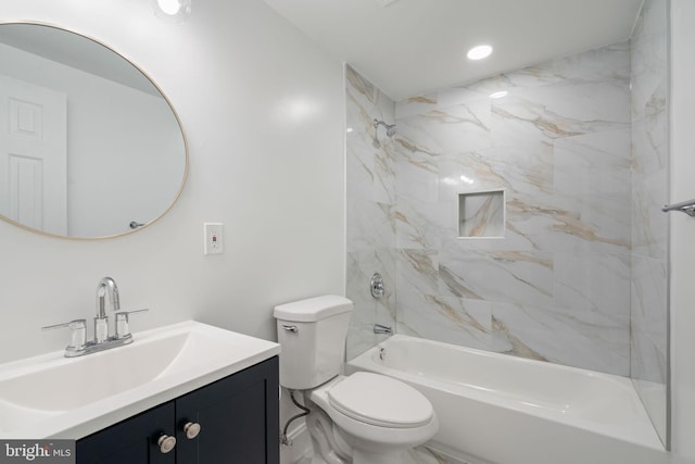 full bathroom with vanity, tiled shower / bath combo, and toilet