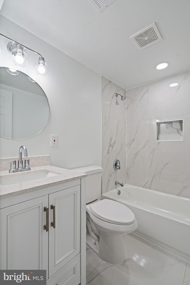 full bathroom featuring vanity, toilet, and tiled shower / bath