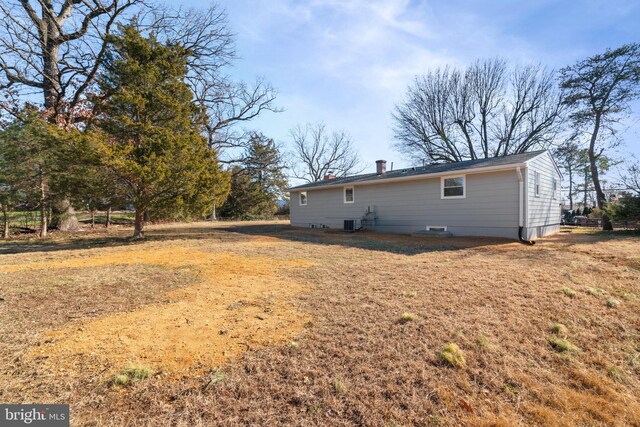 back of property featuring a lawn