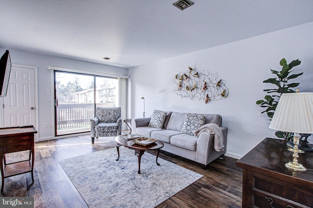 living room with dark hardwood / wood-style flooring