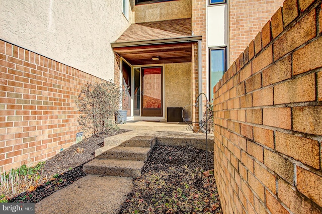 view of exterior entry with a patio