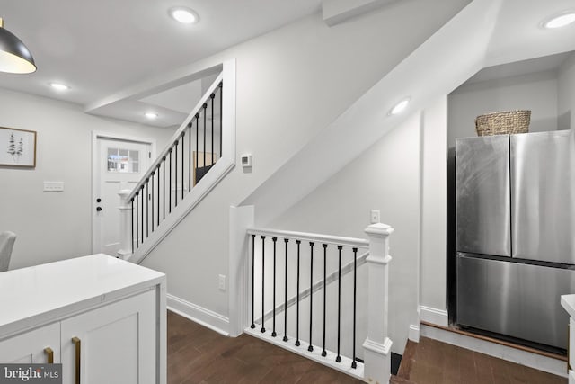 stairway with hardwood / wood-style flooring