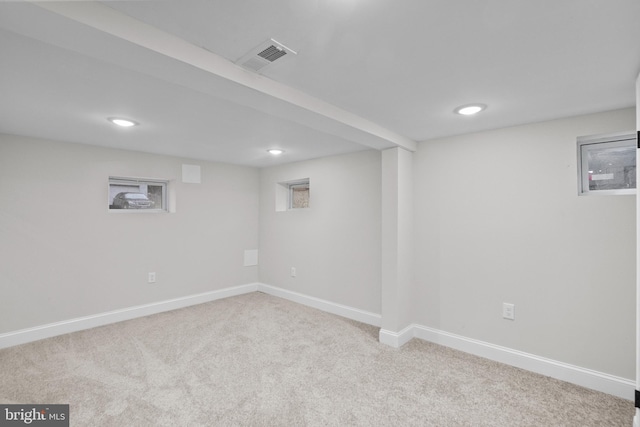 basement featuring light colored carpet