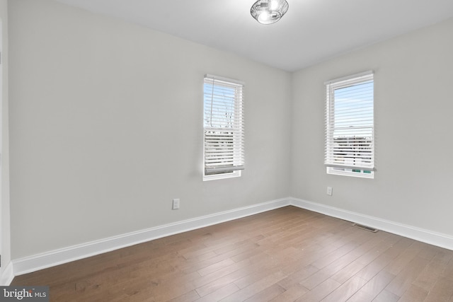 unfurnished room featuring wood-type flooring