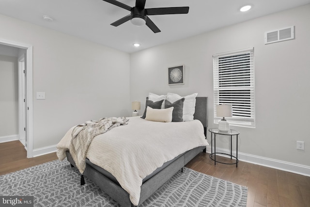 bedroom with dark hardwood / wood-style flooring and ceiling fan