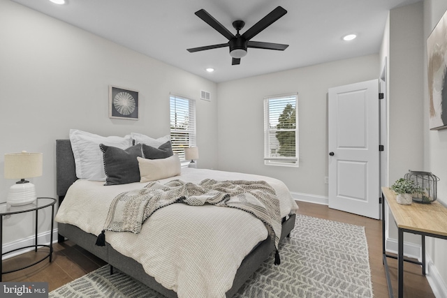 bedroom with ceiling fan and dark wood-type flooring