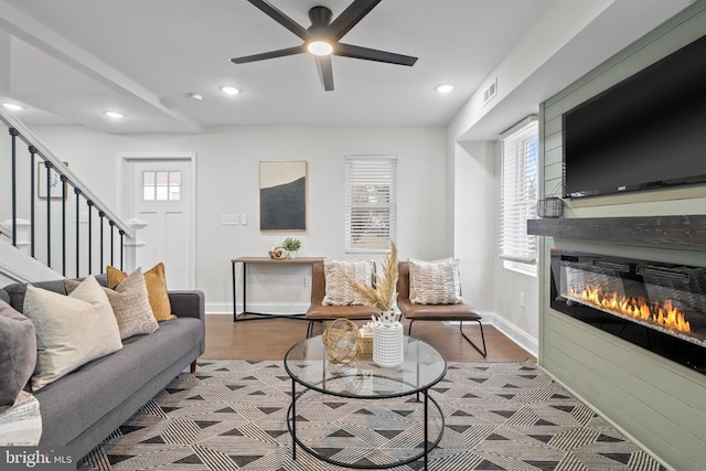 living room featuring hardwood / wood-style flooring and ceiling fan